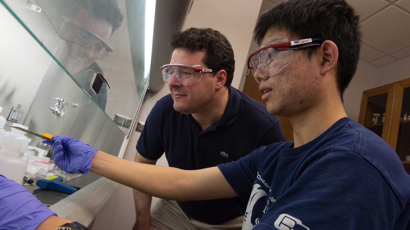 Matteo Pasquali in lab with a student who is pointing